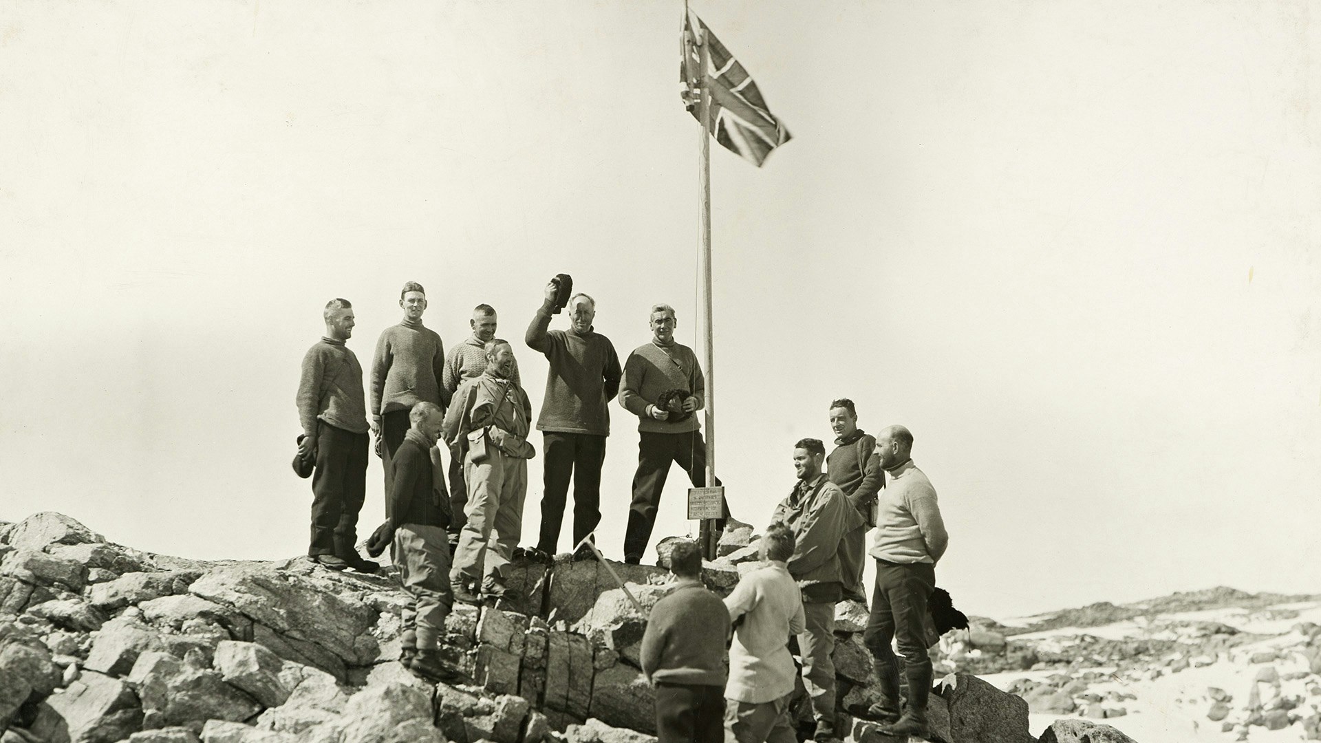 Douglas Mawson (with hat raised) takes possession of the territory explored by the AAE