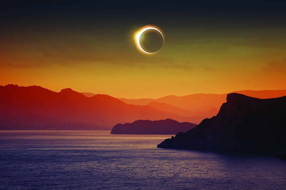 Full Solar Eclipse Over Mountains and Sea, Igor ZH, Shutterstock