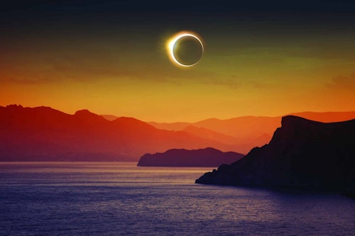 Full Solar Eclipse Over Mountains and Sea, Igor ZH, Shutterstock