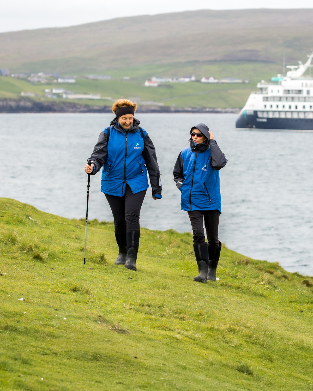 Passengers hiking in Scotland with the Sylvia Earle in the background