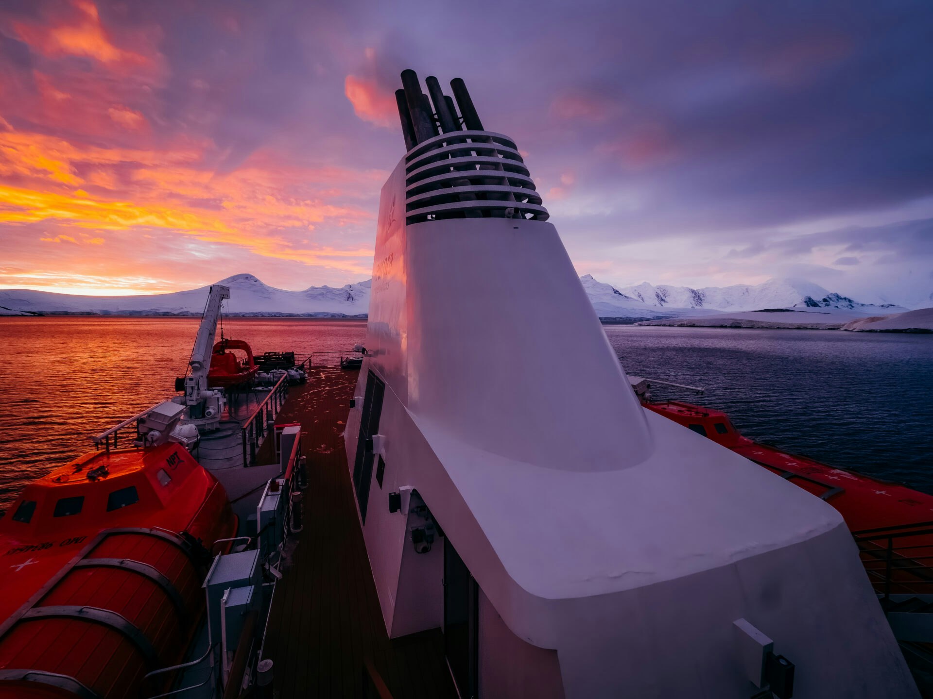 Top of the Greg Mortimer with a dramatic purple sunset behind